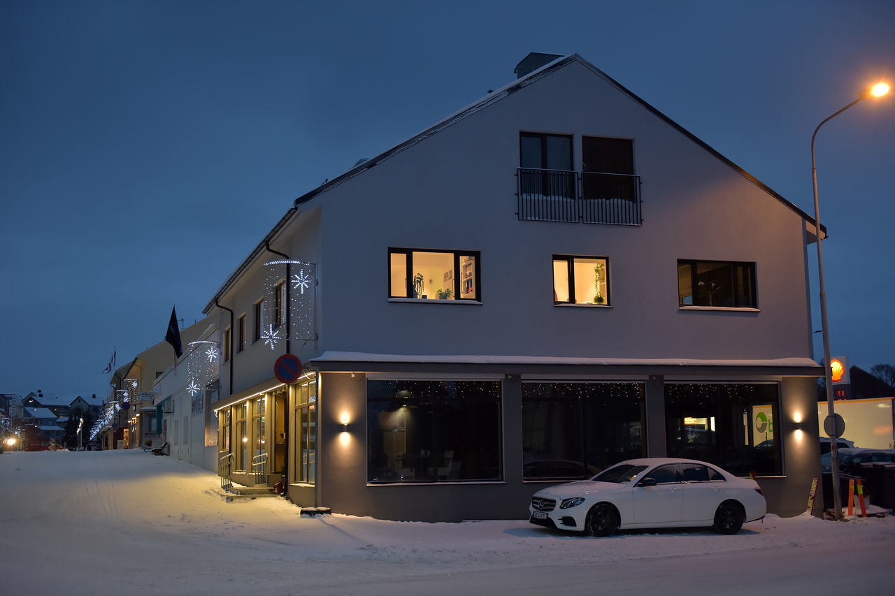 BUILDING AGAINST SKY DURING WINTER AT NIGHT