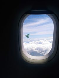 Cloudy sky seen through airplane window