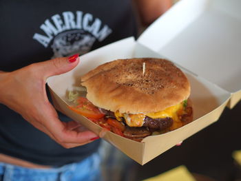 Close-up of woman holding burger
