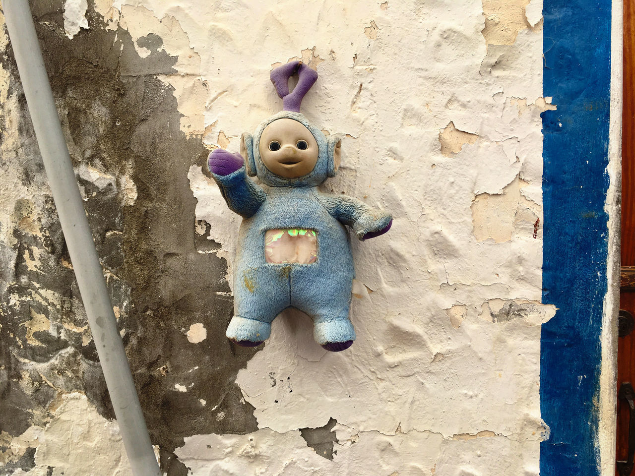 CLOSE-UP OF STUFFED TOY AGAINST WALL