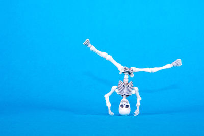 Low angle view of lighting equipment against blue background