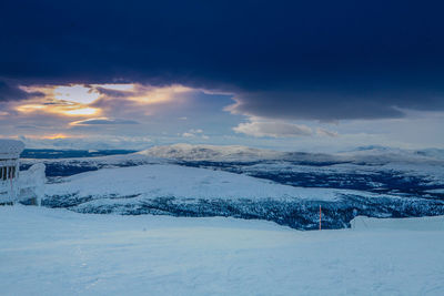 Scenic view of snow covered mountain against blue sky