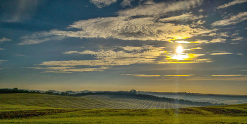 Scenic view of field against sky during sunset