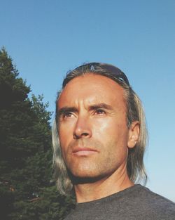 Portrait of mature man against clear sky