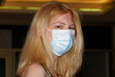 Close-up portrait of woman wearing mask