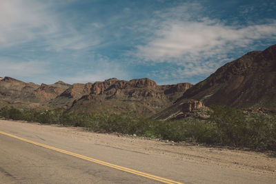 Road by mountains against sky at route 66