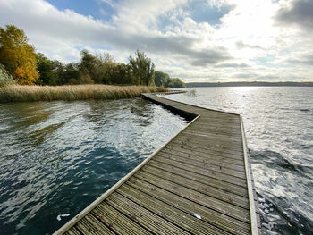 Pier on lake against sky