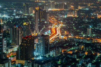 High angle view of city lit up at night