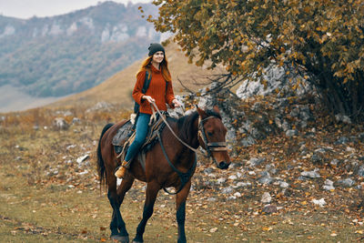 Young woman riding horse