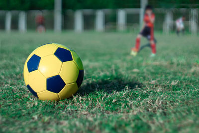 Close-up of soccer ball on field