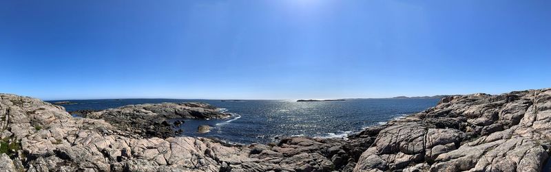 Scenic view of sea against clear blue sky