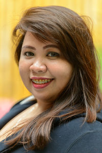 Close-up portrait of smiling young woman