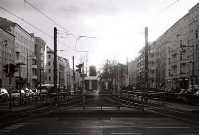 Street amidst buildings against sky in city