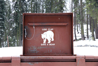 Information sign on snow covered land