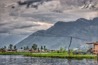 Scenic view of lake against cloudy sky