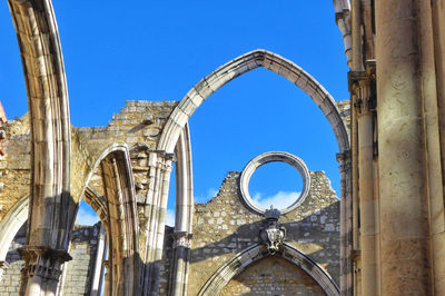 Low angle view of historical building against blue sky