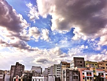 Buildings against cloudy sky