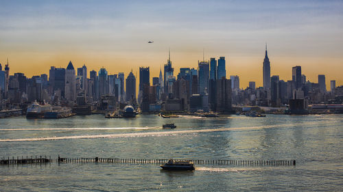 River in front of cityscape against sky