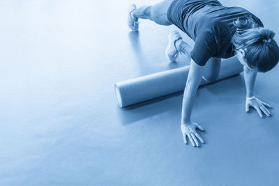 Low section of woman exercising on floor
