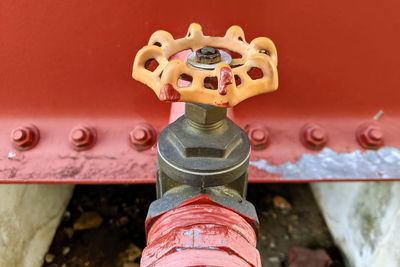 Close-up of fire hydrant against red wall