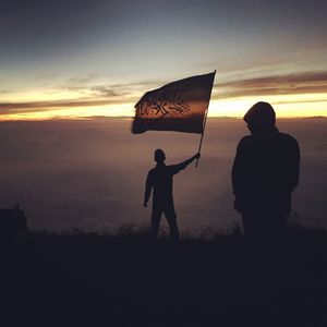 Silhouette of man standing against sky