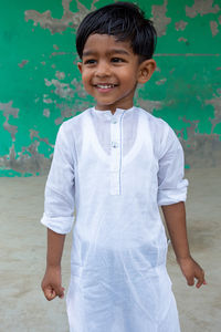 Portrait of smiling boy standing outdoors