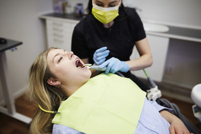 Female dentist with patient in office