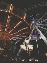 Low angle view of illuminated ferris wheel at night