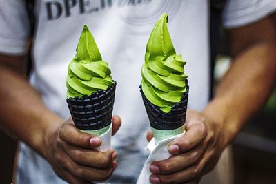 Midsection of man holding ice creams