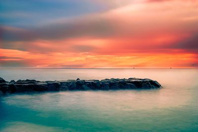 Scenic view of sea against sky at sunset