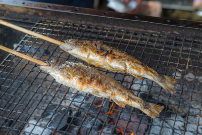 High angle view of meat on barbecue grill