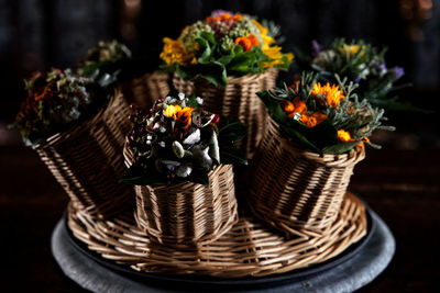Close-up of potted plants in basket on table