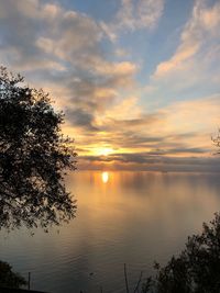 Scenic view of lake against orange sky