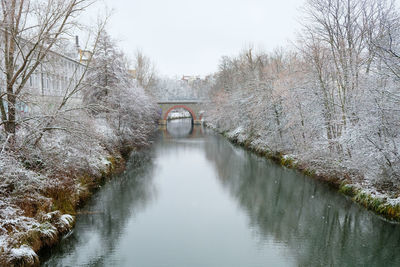 Arch bridge over river against sky