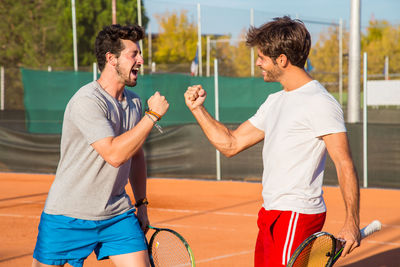 Friends on tennis court