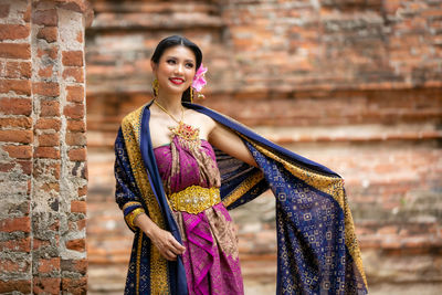 Woman standing against wall