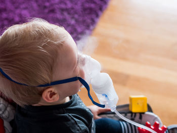 High angle view of cute baby boy taking steam at home