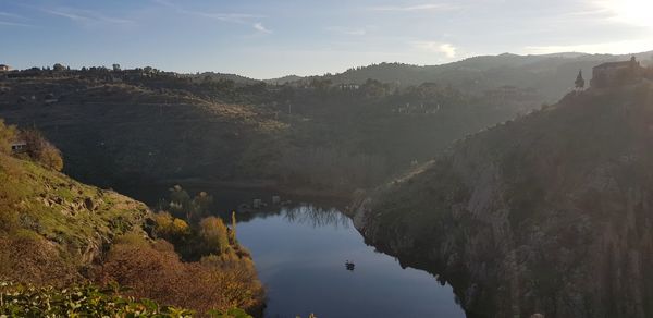 Scenic view of lake and mountains against sky