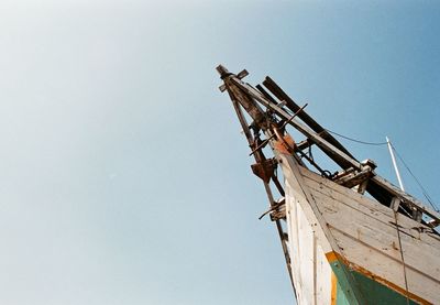 Low angle view of crane against clear sky