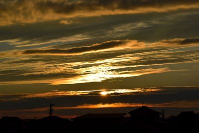 Silhouette buildings against sky during sunset