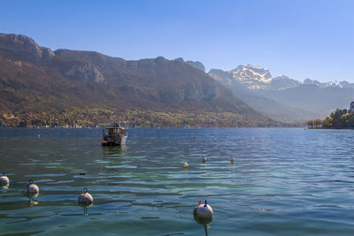 Buoys in lake against sky