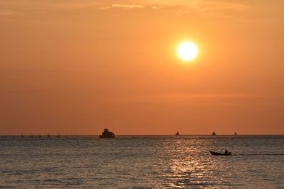 Scenic view of sea against orange sky