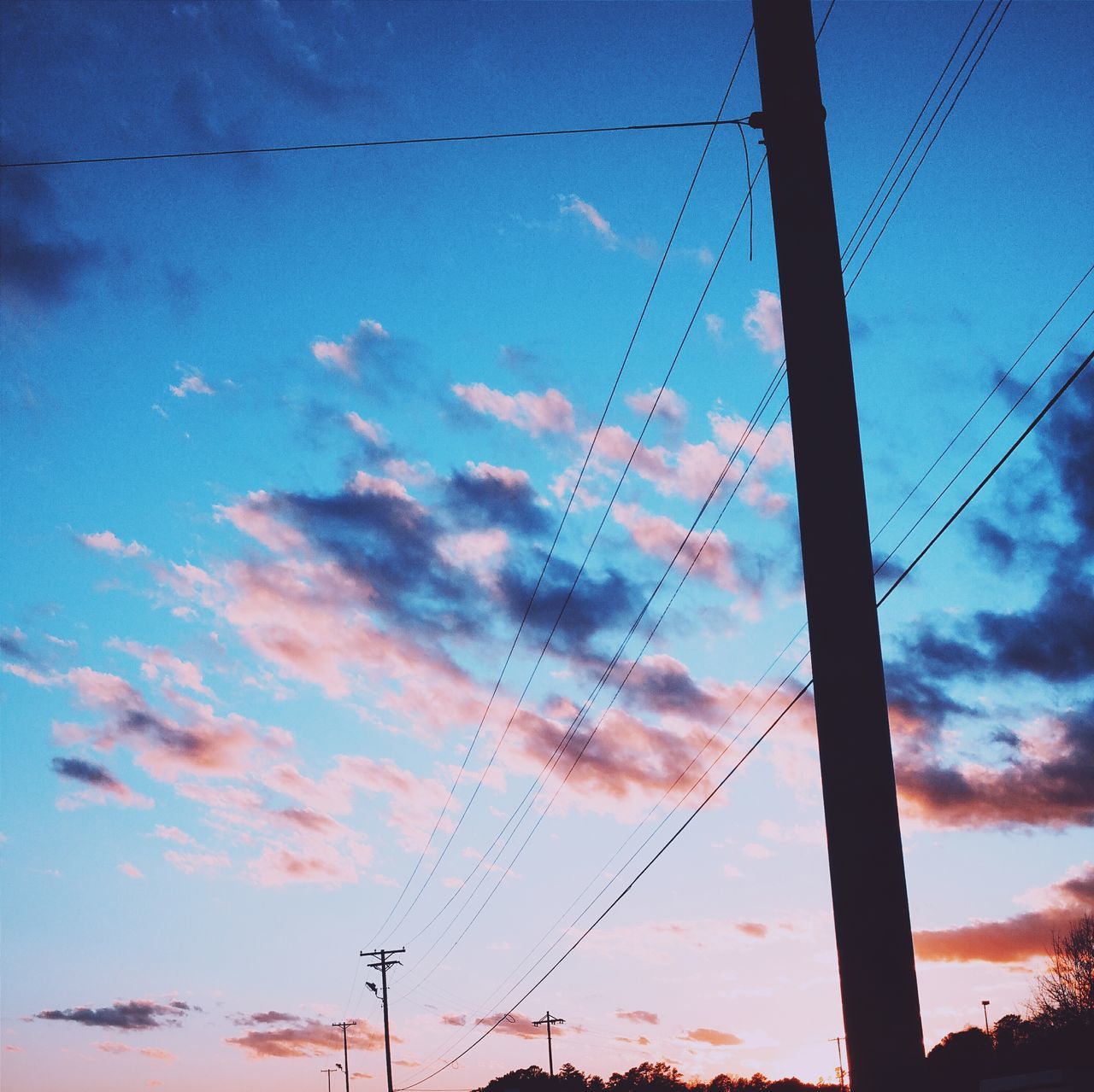 power line, electricity pylon, low angle view, power supply, fuel and power generation, electricity, sky, silhouette, technology, connection, cable, sunset, blue, cloud - sky, cloud, dusk, outdoors, no people, power cable, nature