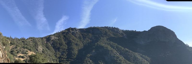 Low angle view of mountain against blue sky