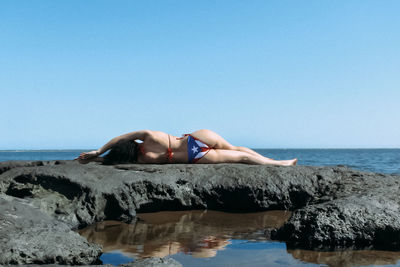 Man in sea against clear sky