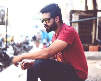 Man in sunglasses sitting outdoors