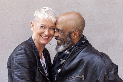 Portrait of cool mature biker couple in leather clothes