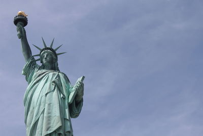 Statue of liberty against blue sky