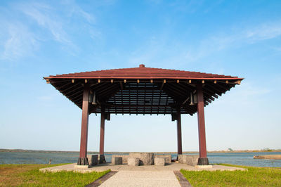 Gazebo on beach against sky