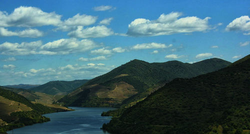 Scenic view of mountains against cloudy sky